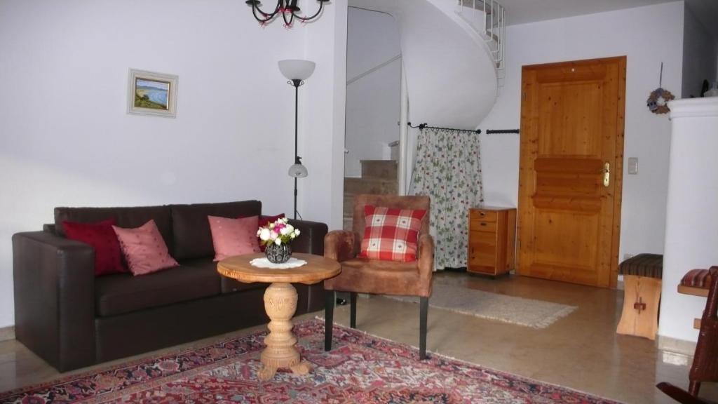 a living room with a couch and a table at Apartment Jasmin in Garmisch-Partenkirchen
