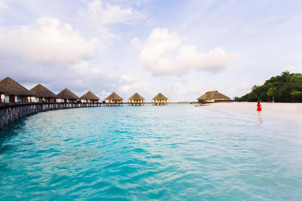 a beach with overwater bungalows and the ocean at Adaaran Prestige Water Villas - with Dine around Premium All inclusive - 24 hours in Raa Atoll