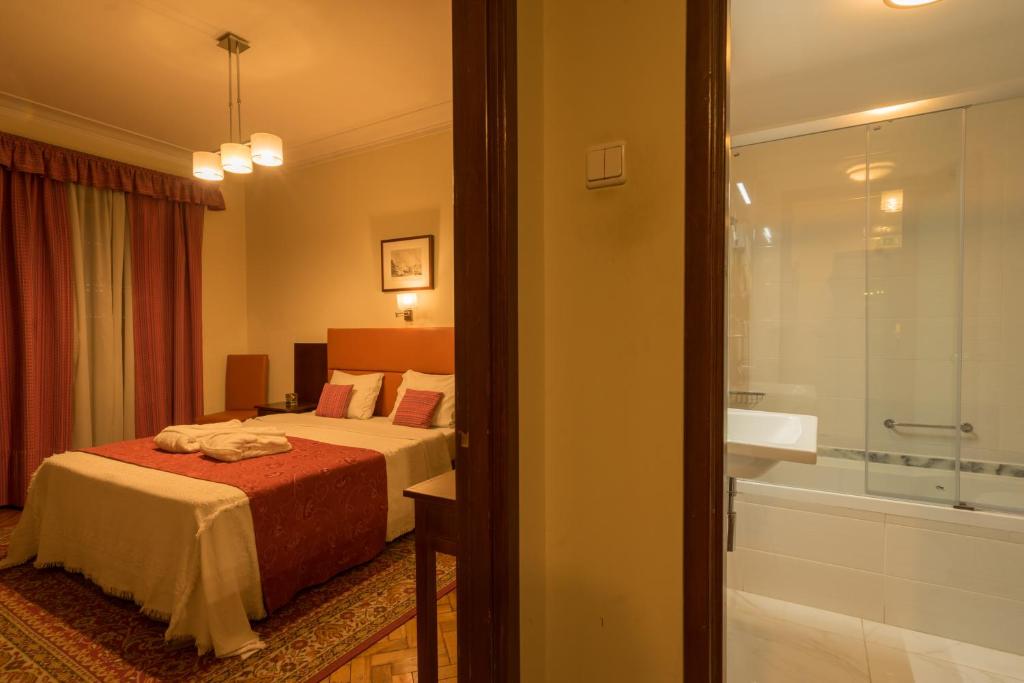 Postel nebo postele na pokoji v ubytování Pao de Acucar Hotel