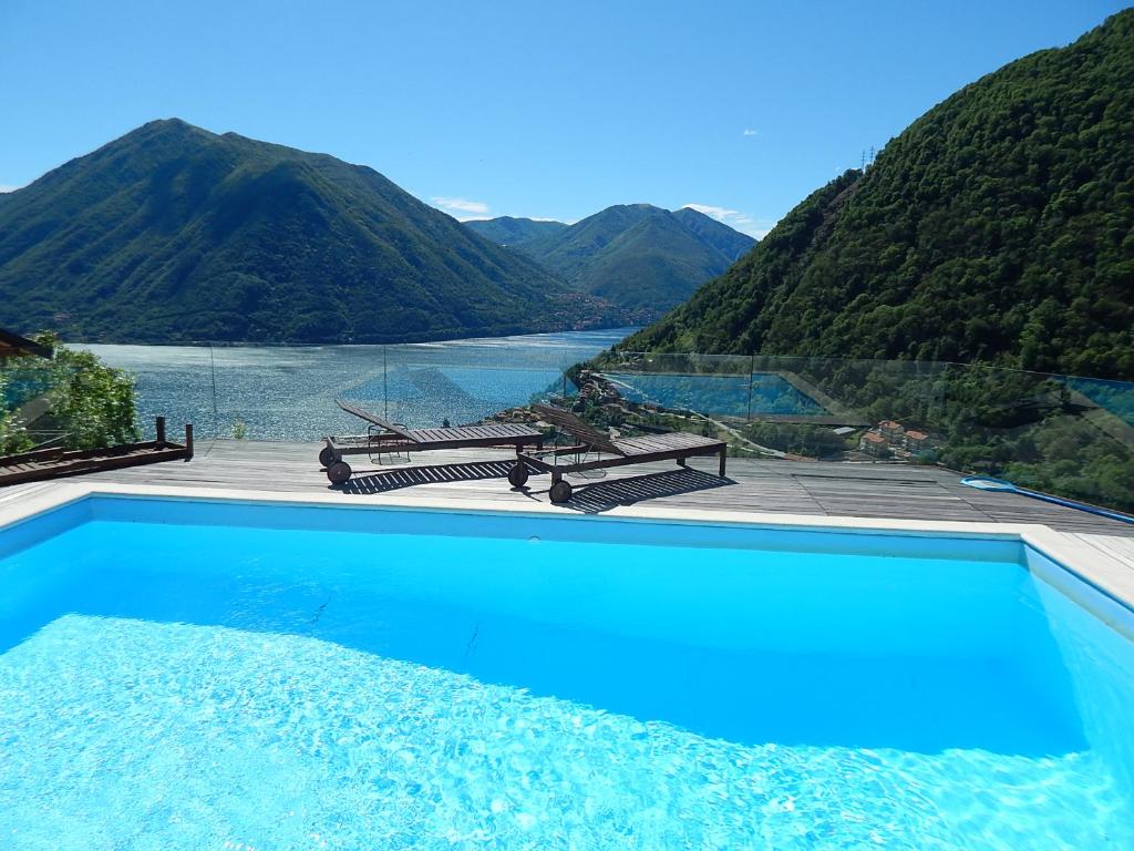 a swimming pool with a view of a mountain at Villa Lilla in Argegno