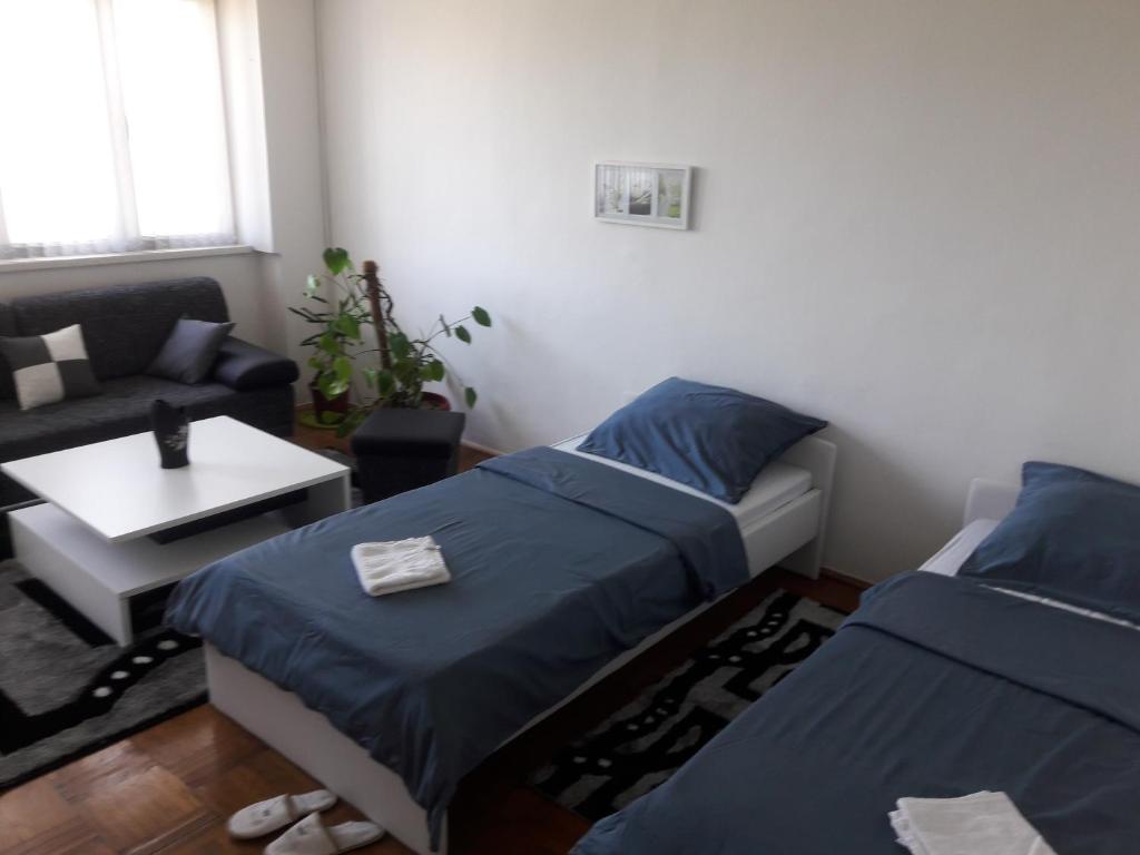 a living room with two beds and a couch at Apartment Beton in Bihać