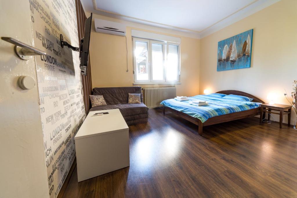 a living room with a bed and a couch at Parliament Apartment in Belgrade