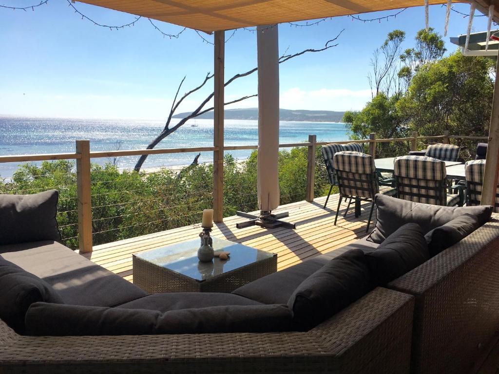 a living room with a couch and a view of the ocean at The Beach Shack in Emu Bay