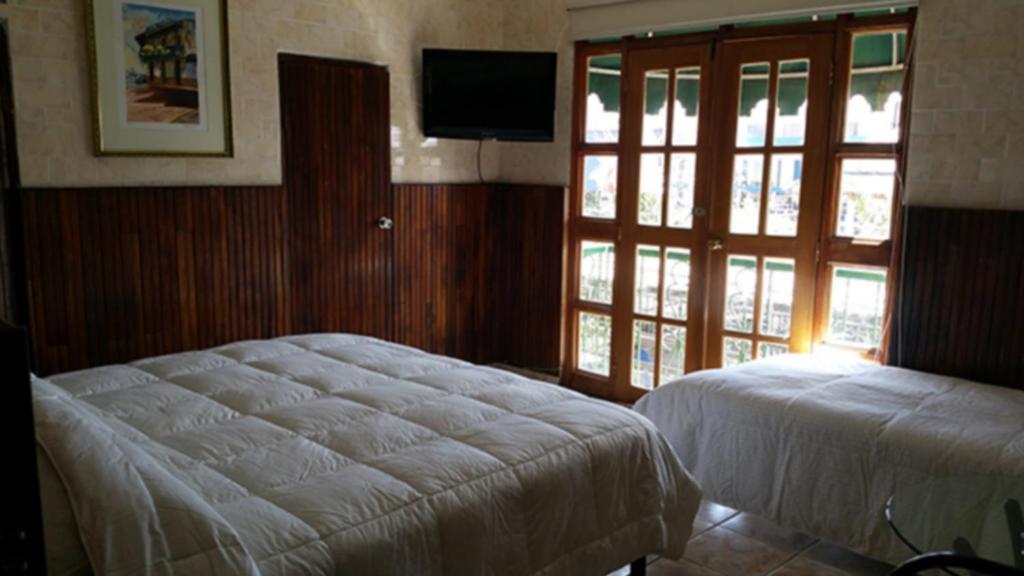 Postel nebo postele na pokoji v ubytování Hotel Rex