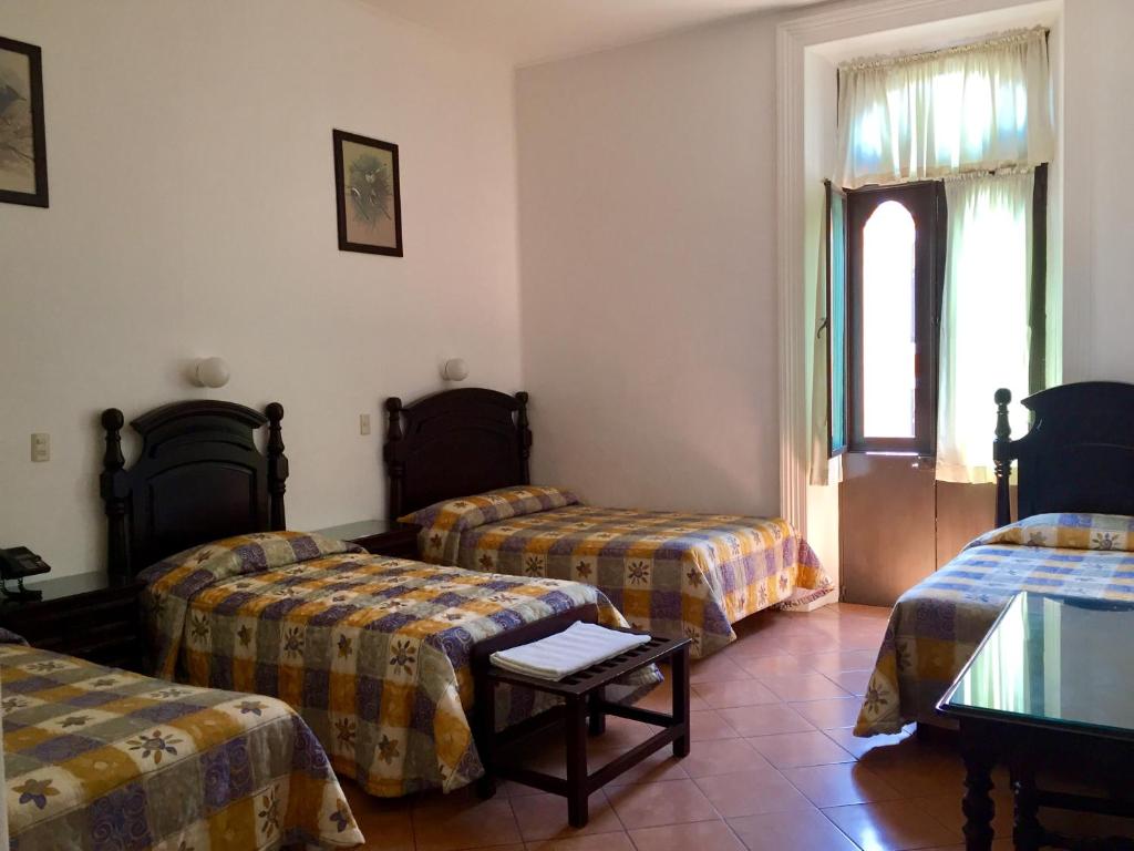 Postel nebo postele na pokoji v ubytování Hotel de los baños