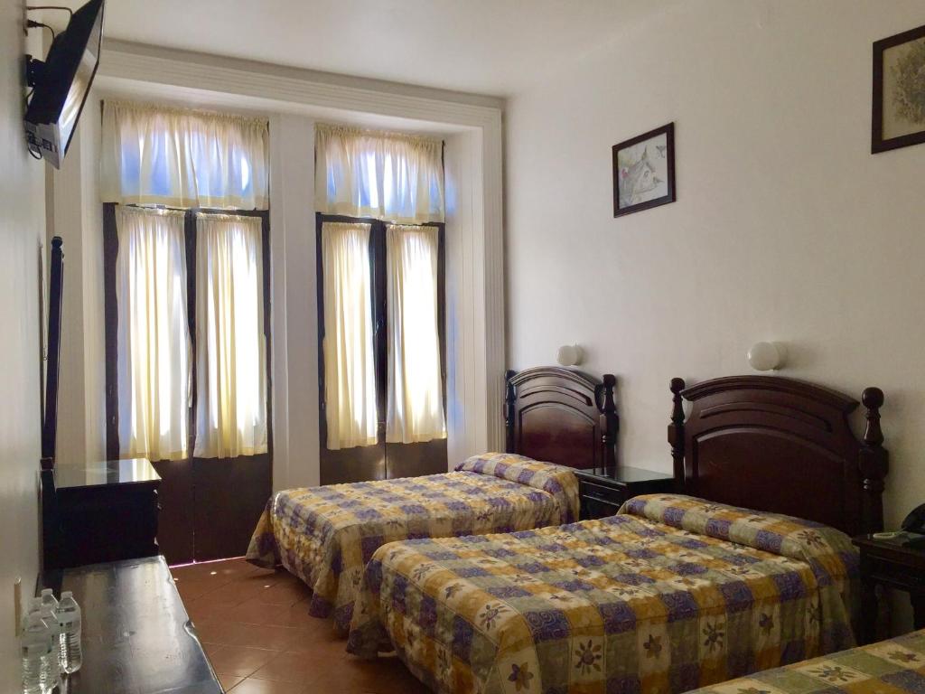Postel nebo postele na pokoji v ubytování Hotel de los baños