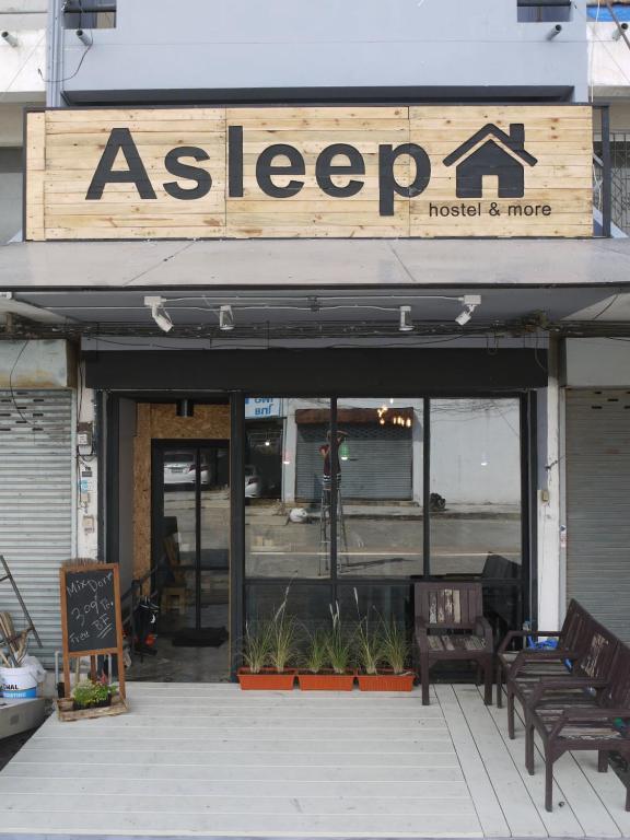 a building with a sign that reads as leeper at Asleep Hostel in Kanchanaburi