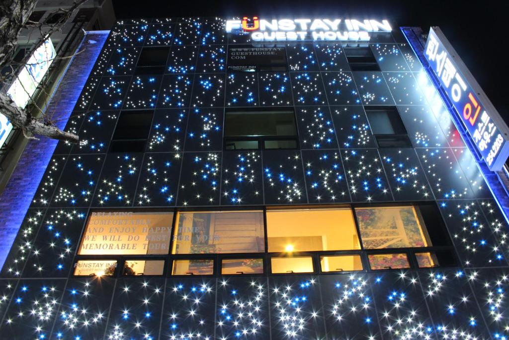 a building with christmas lights on the side of it at Funstay Inn Guesthouse in Busan