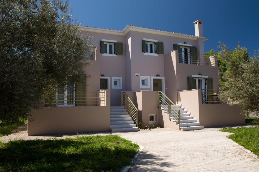 a large house with stairs in front of it at Alegria Boutique Villas in Lygia