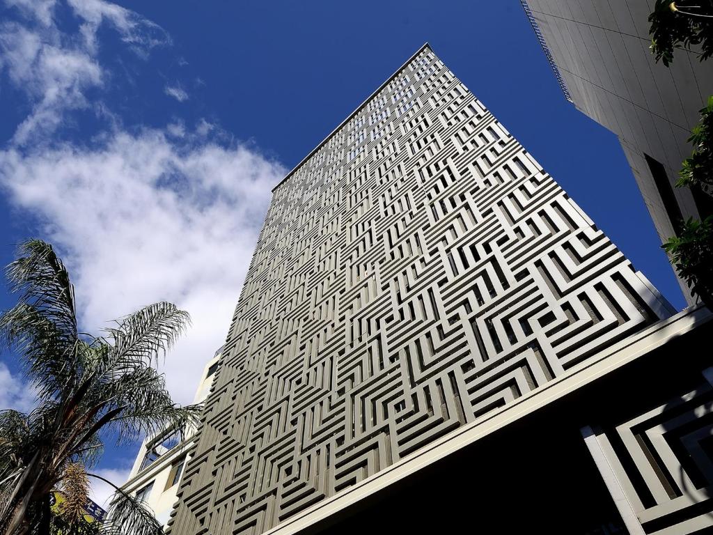 a tall building with a black and white pattern on it at Aroma Chew Hotel in Taichung