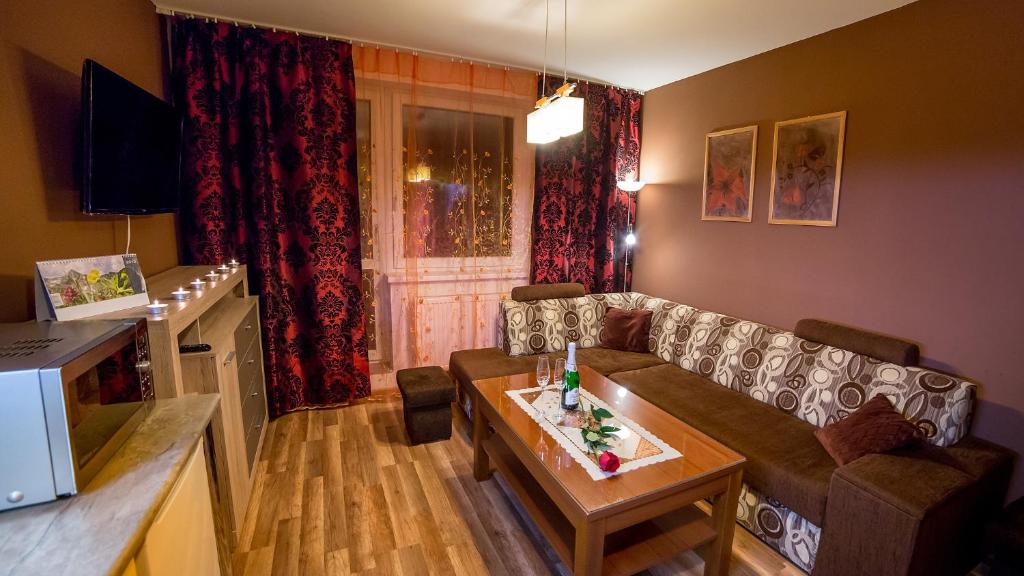 a living room with a couch and a table at High Tatras - Patris 27 in Tatranska Strba