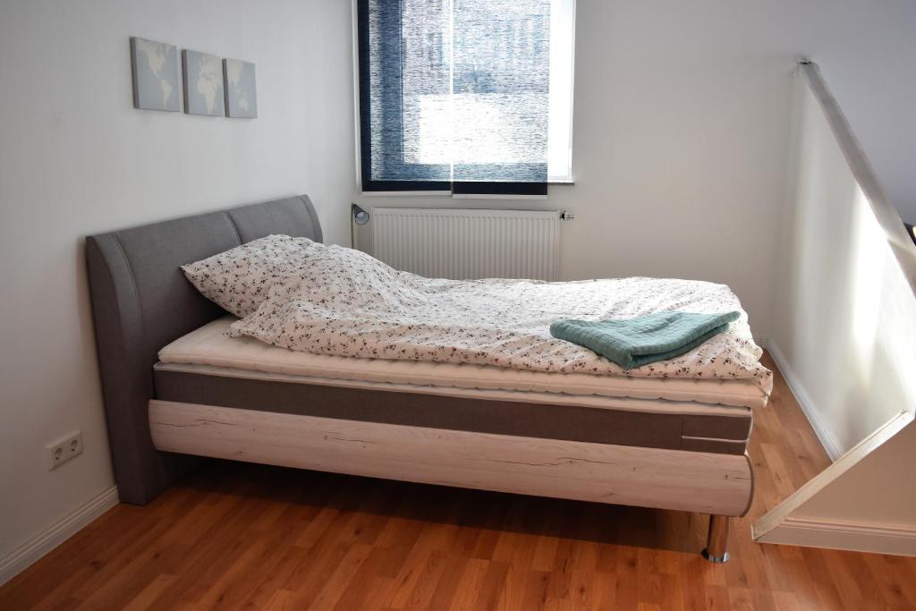 a small bed in a room with a window at Work & stay exclusive apartment in Düsseldorf