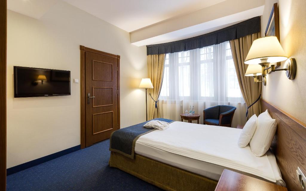 Posteľ alebo postele v izbe v ubytovaní Bukowy Park Hotel Medical SPA