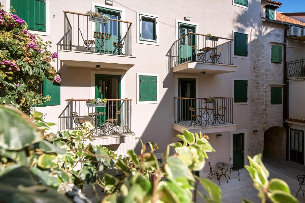 an apartment building with balconies and plants at Apartments Korta in Split