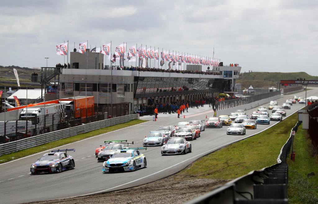 a group of cars racing on a race track at Studio Sautille in Zandvoort
