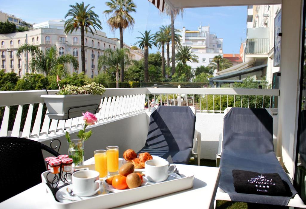 a tray of fruit on a table on a balcony at Hôtel Victoria in Cannes