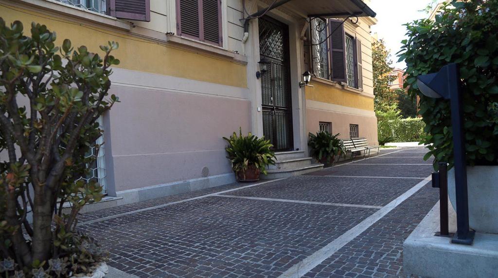 a cobblestone street in front of a building at Roma Room Hotel in Rome