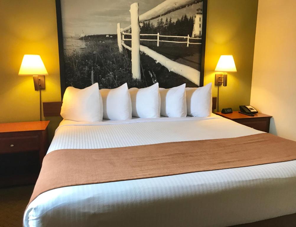 
a hotel room with a bed and a lamp at Super 8 by Wyndham Amherst NS in Amherst
