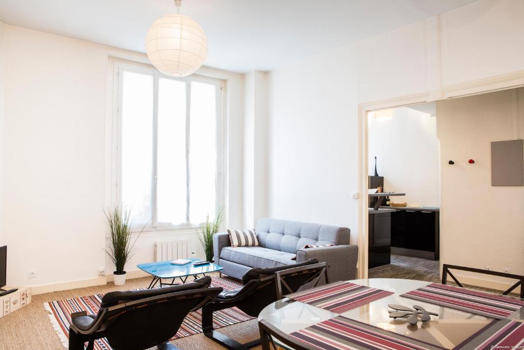 un salon avec un canapé, une table et des chaises dans l'établissement Martinique Nice apartment, à Bordeaux