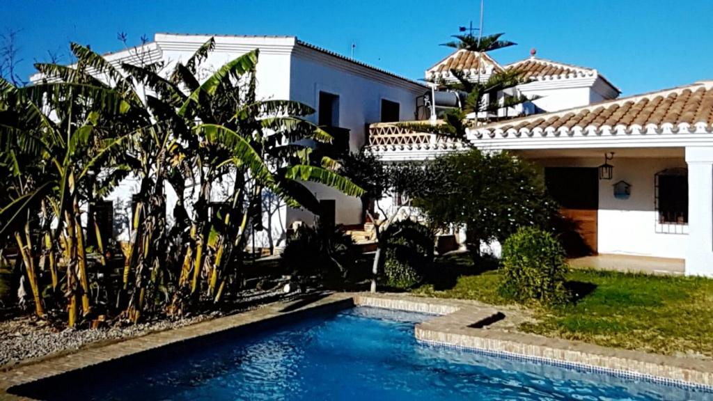 a swimming pool in front of a house at Cortijo de Don Victor in Vera