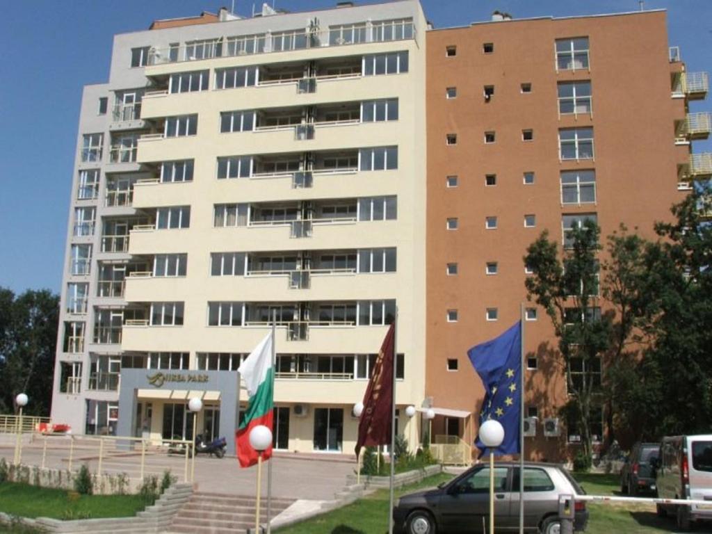 a large white building with flags in front of it at NikeaPark in Golden Sands
