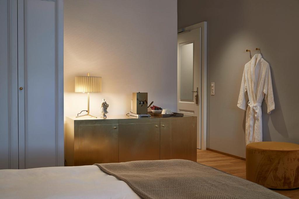 Postel nebo postele na pokoji v ubytování Boutique Hotel La Couronne