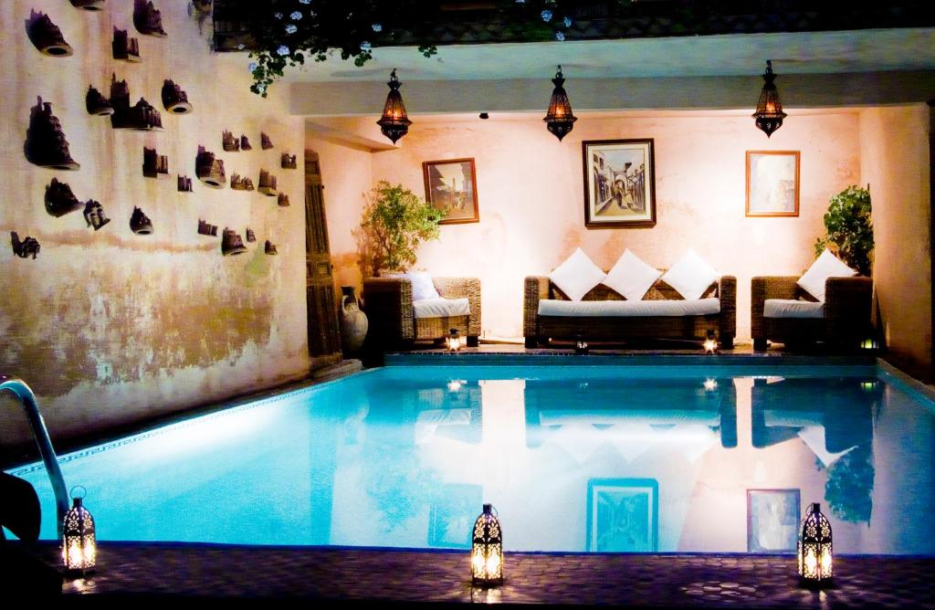 a large swimming pool in a living room at Le Riad Meknes in Meknès
