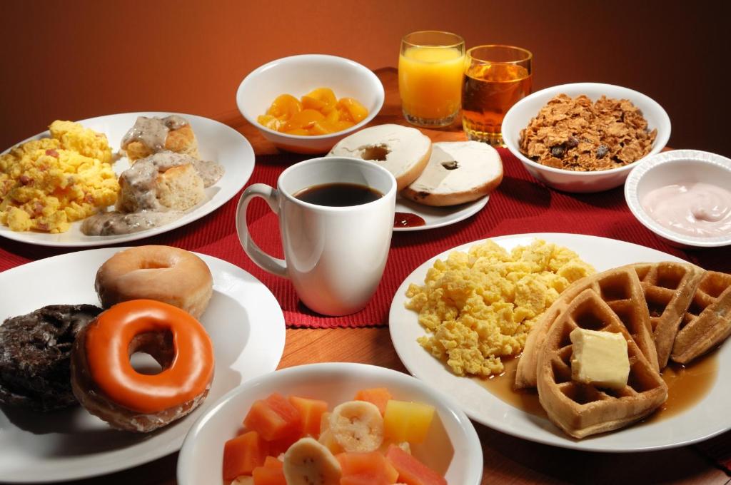 a table topped with plates of breakfast foods and drinks at Lodge of the Ozarks in Branson