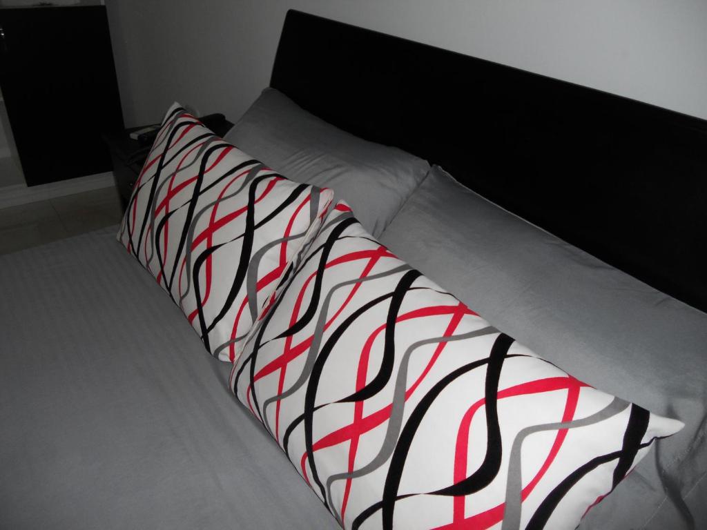 Postel nebo postele na pokoji v ubytování Hotel Cosmos Sincelejo