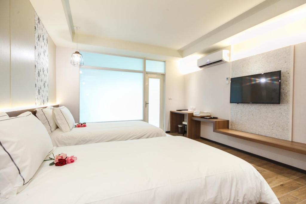 Postel nebo postele na pokoji v ubytování Da Pu Hotspring Hotel