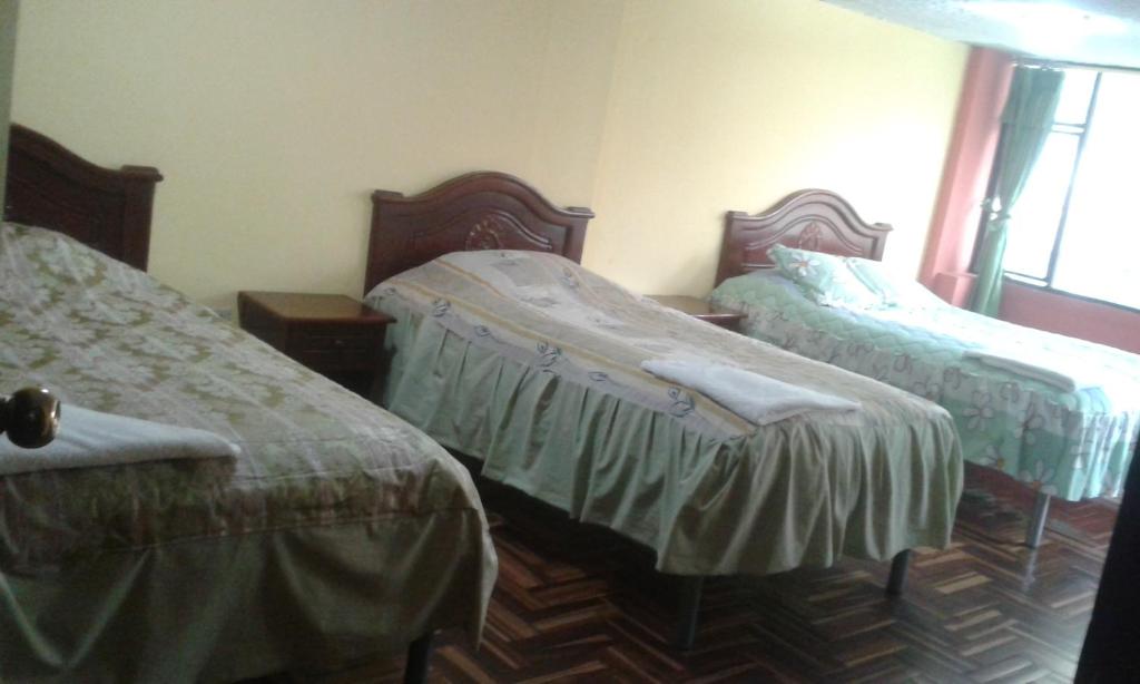 Postel nebo postele na pokoji v ubytování Hostal Pucará