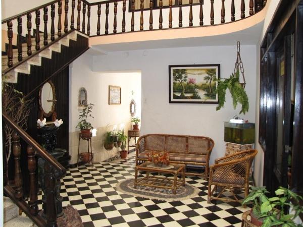 a living room with a staircase and a bench at Hotel La Torre in Tupiza