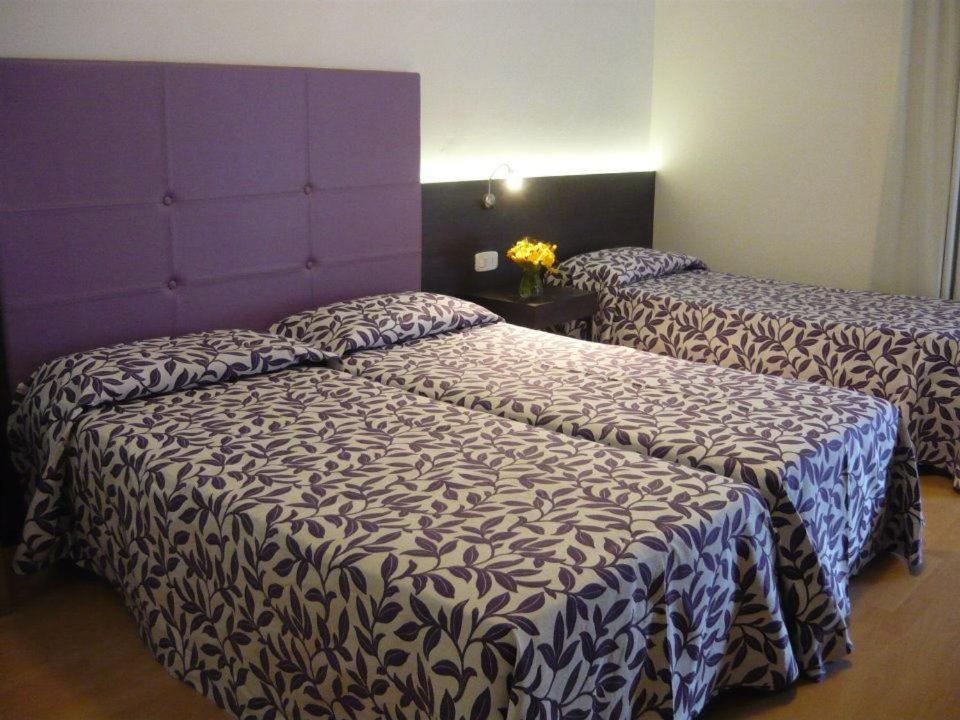 Postel nebo postele na pokoji v ubytování Hotel Lily