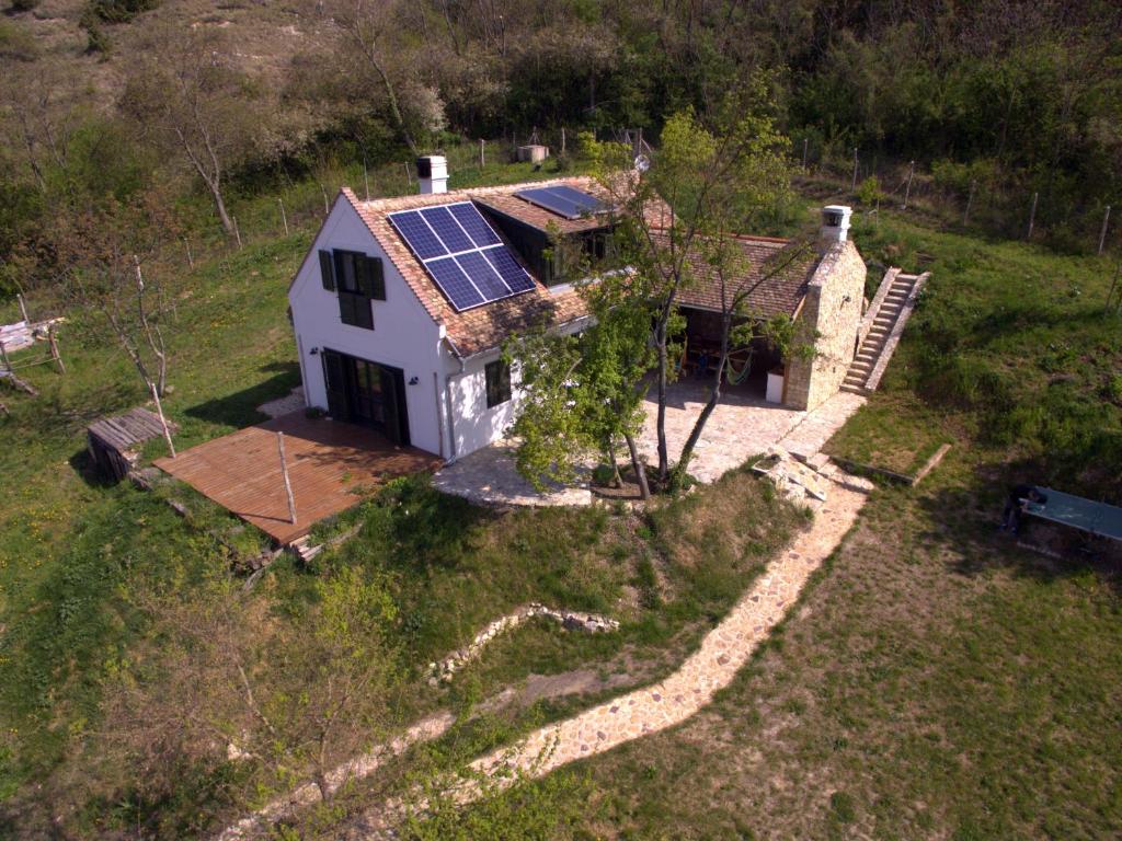 an aerial view of a house with solar panels on the roof at Henye holiday homes in Balatonhenye