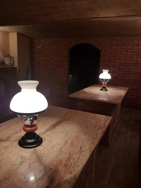 two lights on a table in a room with a fireplace at Pension Sunset Mezirolí in Nová Role