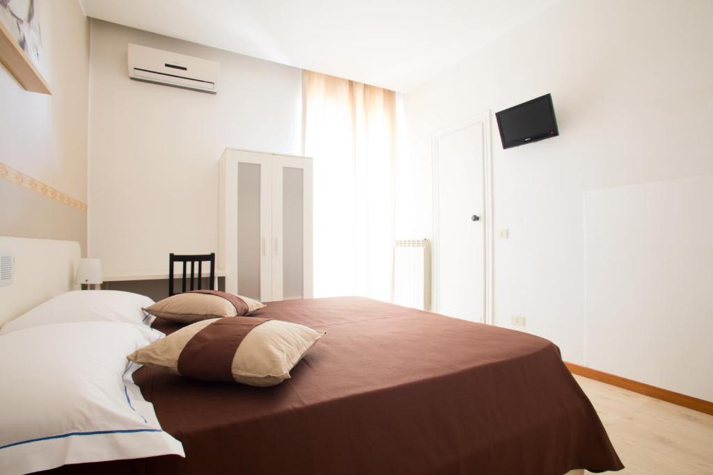 Postel nebo postele na pokoji v ubytování Hotel Indipendenza