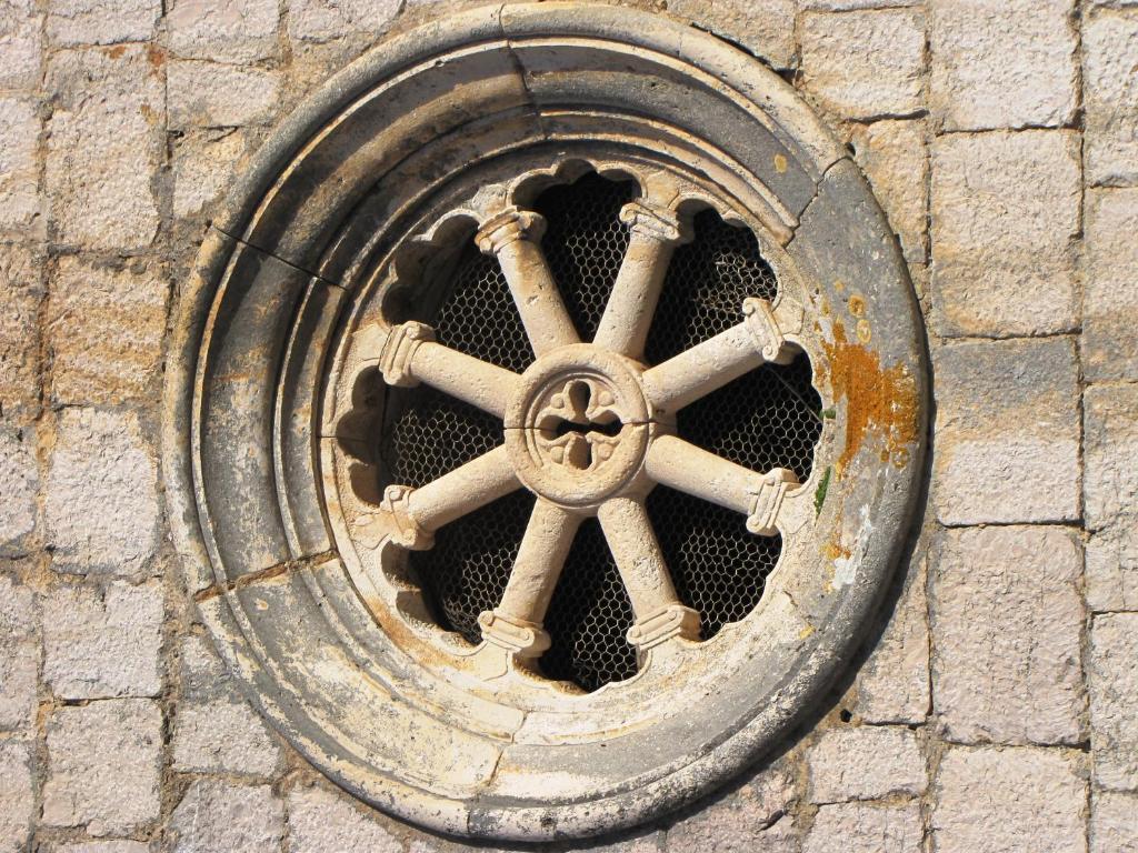 a metal manhole cover on a brick wall at Apartments Luza in Lastovo