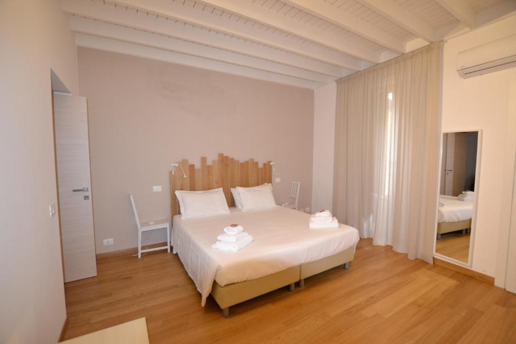 ein Schlafzimmer mit einem großen weißen Bett in einem Zimmer in der Unterkunft Tambù Apartments in Catania