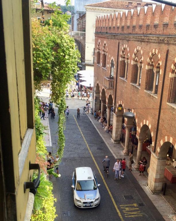 Hotel Casa Martini Piazza Erbe, a car parked on a street next to a building at Casa Martini Piazza Erbe in Verona