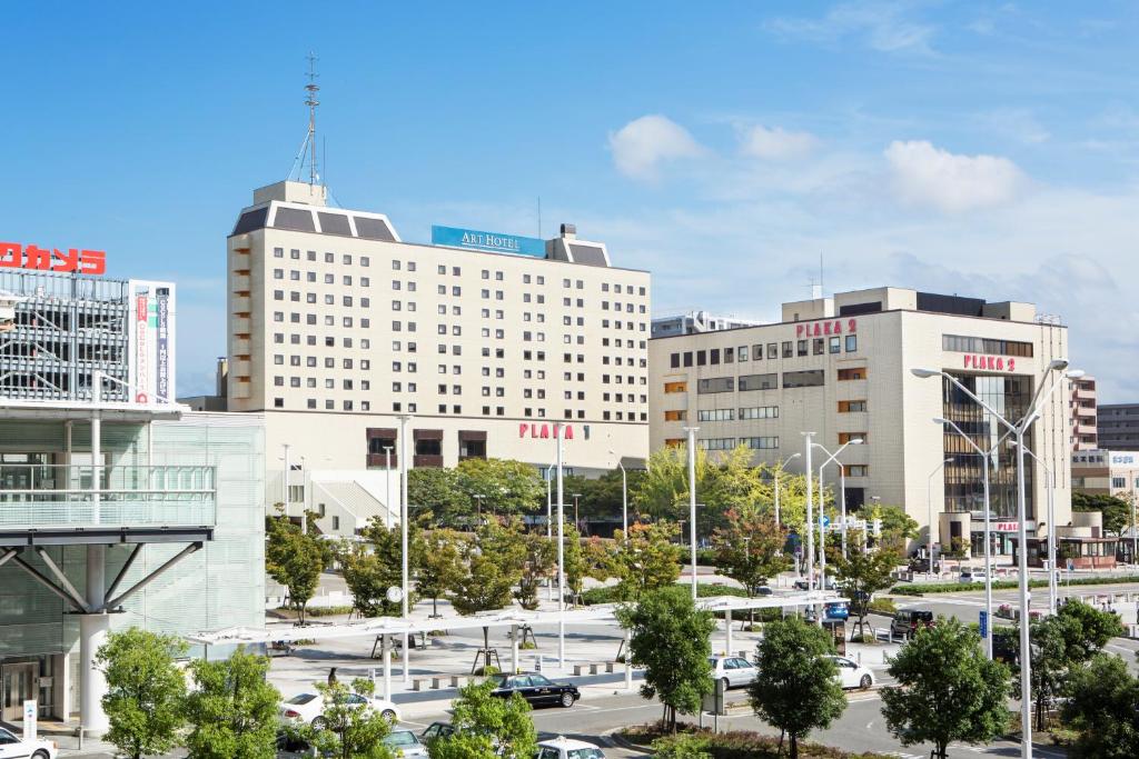 a city with tall buildings and a parking lot at Art Hotel Niigata Station in Niigata