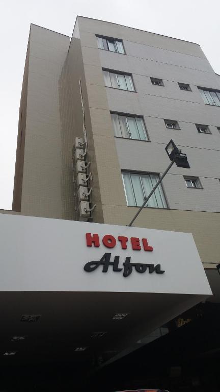 a hotel alfred sign in front of a building at Alfon Hotel in Itabira
