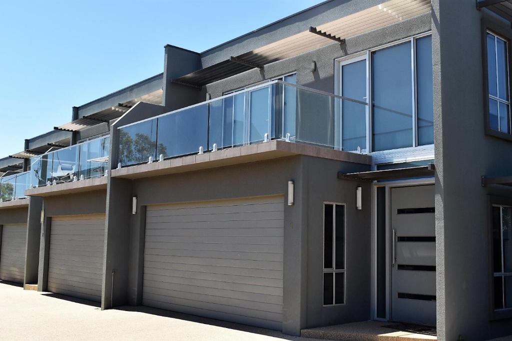 a house with a balcony and a garage at Griffith Prestige Apartments in Griffith