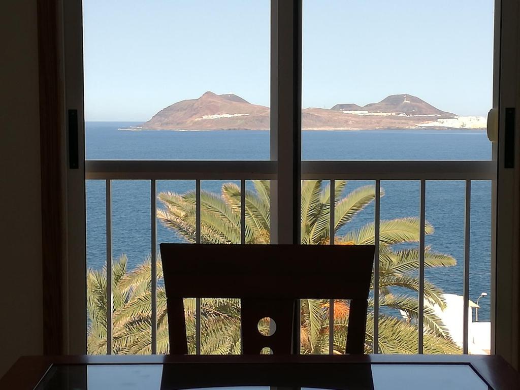a view of the ocean from a window at Apartamento mirador del Mar in Las Palmas de Gran Canaria