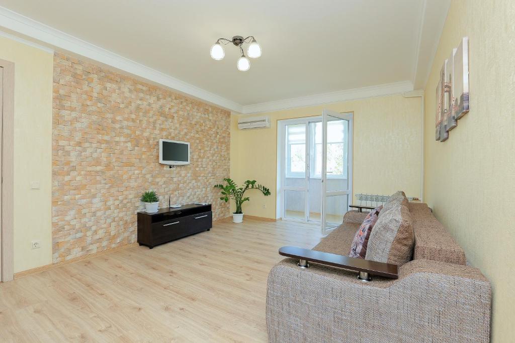 a living room with a couch and a tv at Apartment on Obolonskiy Prospect 16V in Kyiv