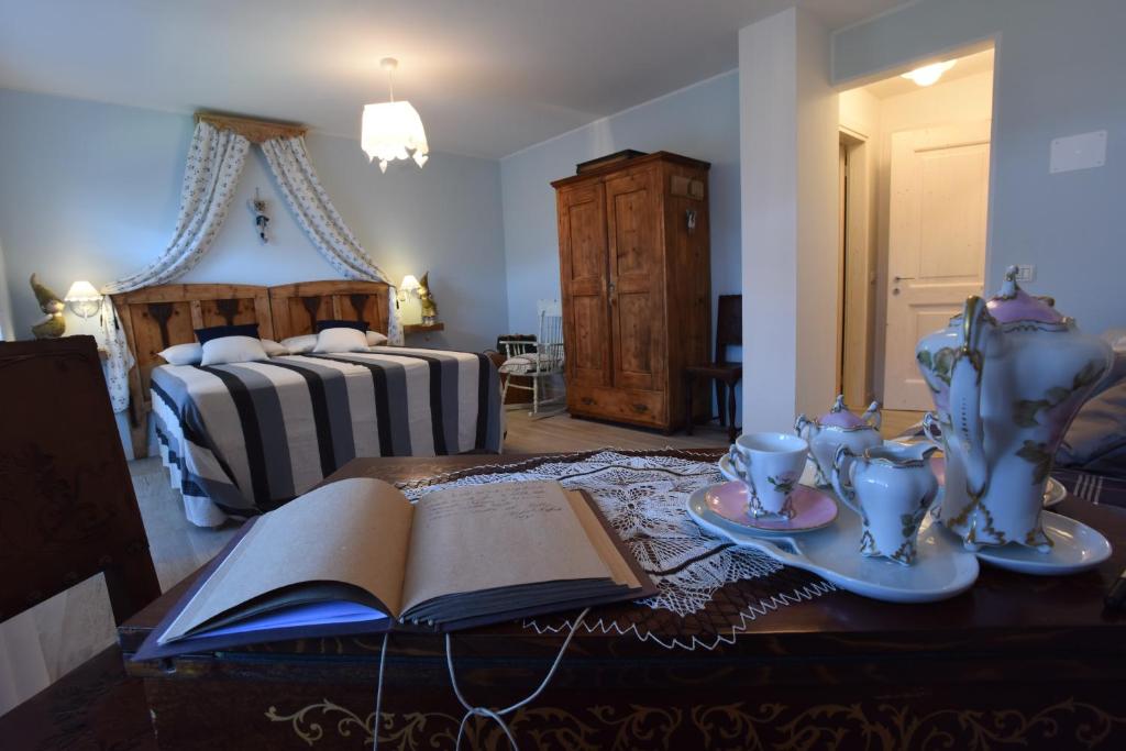 a bedroom with an open book on a table with a bed at B&B Magiré in Tesero