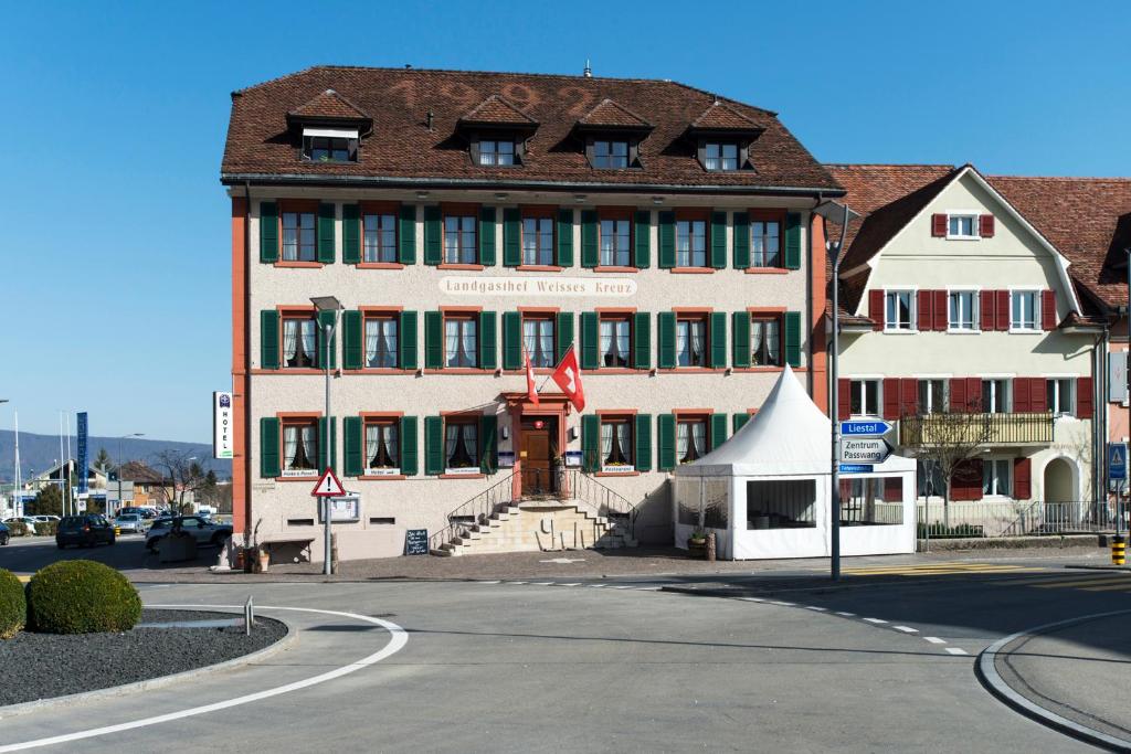 a large building on the corner of a street at Hotel-Restaurant Weisses Kreuz in Breitenbach