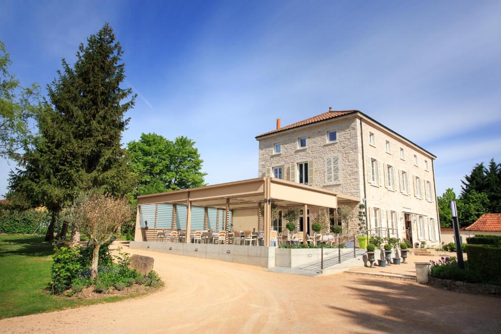 a building with people sitting outside of it at La Marande in Montbellet