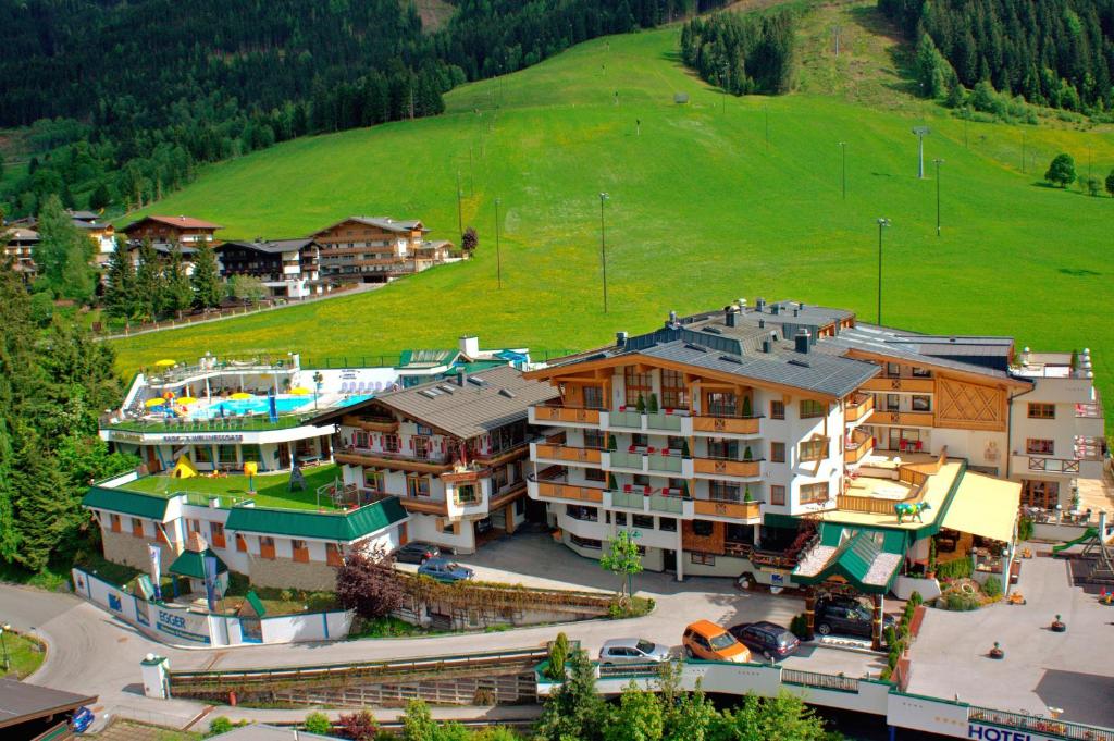 an aerial view of a resort with a pool at Wellness- und Familienhotel Egger in Saalbach-Hinterglemm