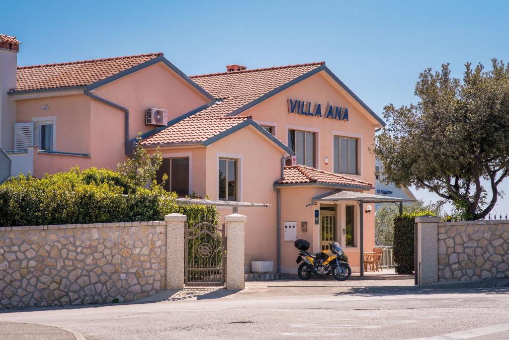 dom z motocyklem zaparkowanym przed nim w obiekcie B&B Villa Ana w Krku