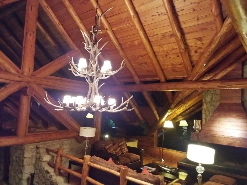 a chandelier hanging from the ceiling of a building at Dos Bahias Lake Resort in Villa La Angostura
